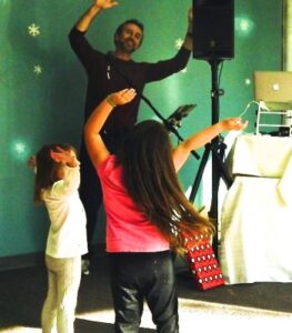 Two children dancing with DJ Eric Everett