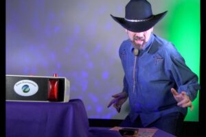 Eric Everett with cowboy hat and denim shirt pretending he is game show player