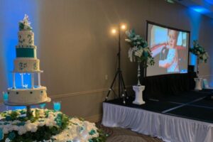 Wedding cake and stage with wedding slideshow