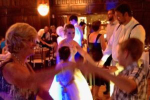 3 generations of family dancing at wedding reception